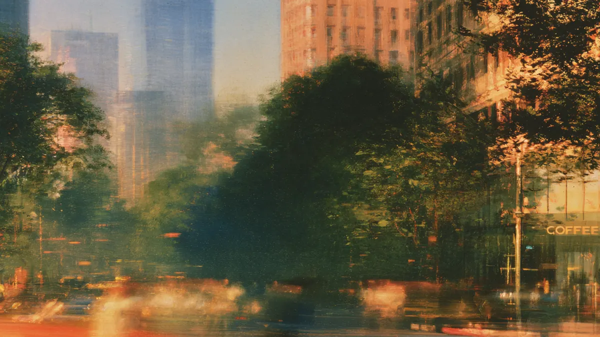 A blurred evening street downtown, crowds and traffic streaming past tall buildings